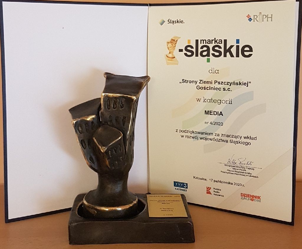 Grafika przedstawia statuetkę oraz list gratulacyjny