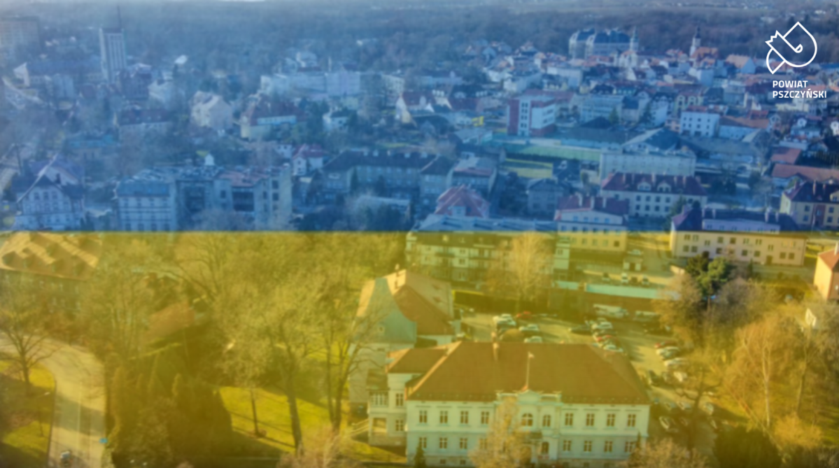 budynki widziane z lotu ptaka, przyktyte niebiesko żółtym tłem - w barwach flagi Ukrainy.